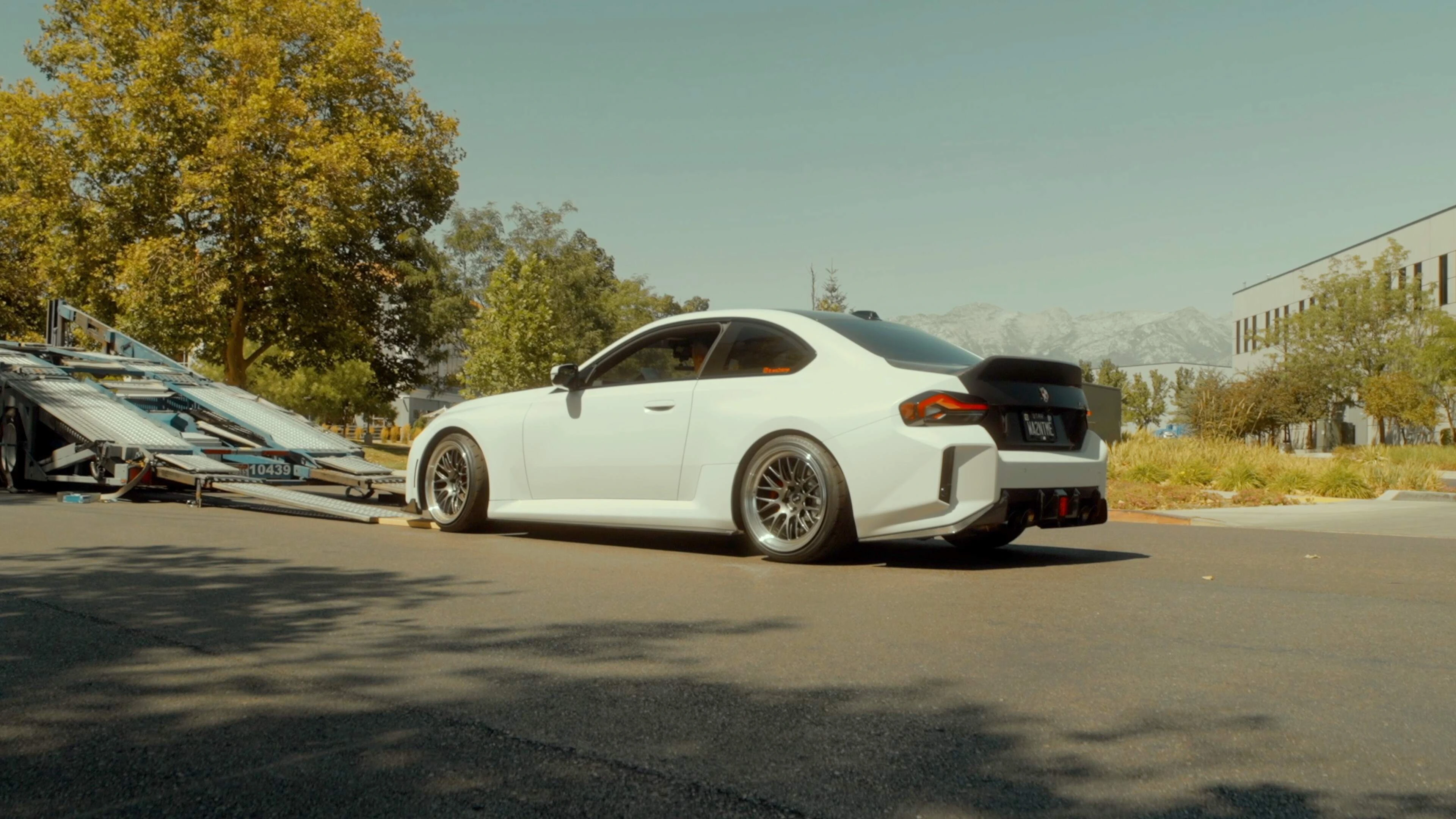 White BMW M2 unloaded from the hauler