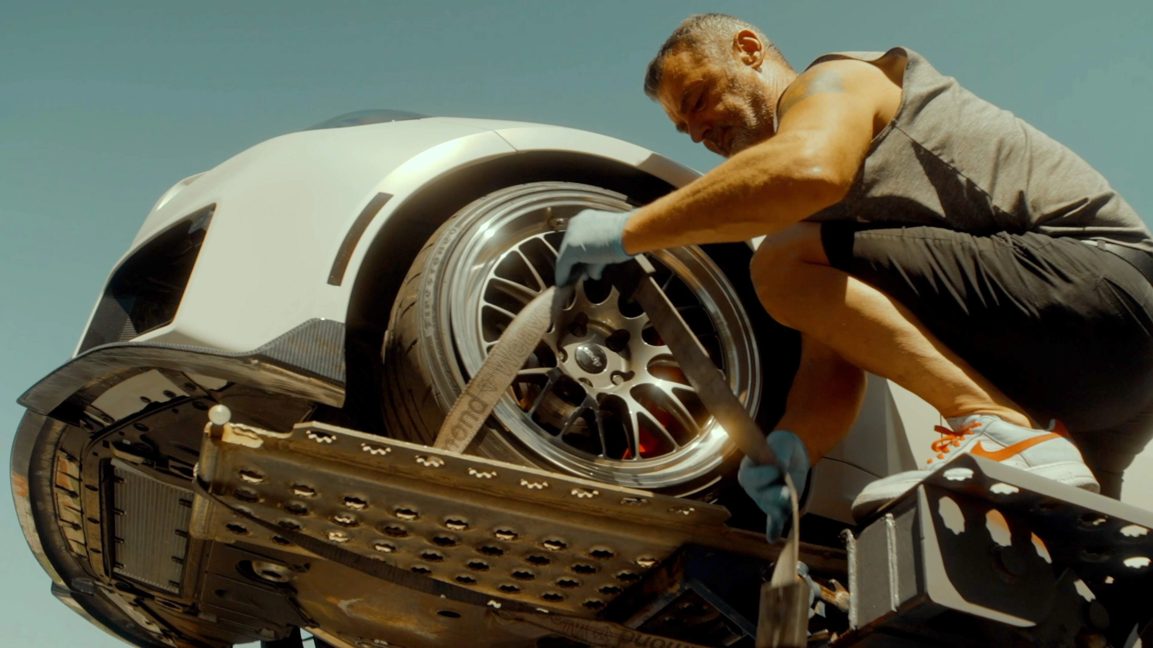 Strapping a wheel down on the hauler